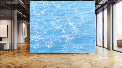 Sun light reflecting or sparkling glitter on water of sea or ocean with beautiful sky blue light tone. Wall mural