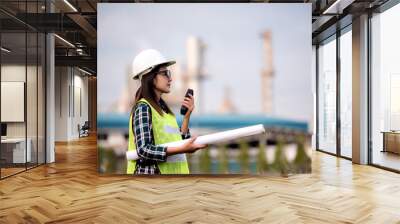  Asian engineer on construction site check documents plan on construction site ,Industry ,Engineer and safety concept .  Wall mural