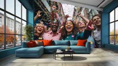 A happy diverse team of startup business people celebrate their business success amidst confetti. Wall mural