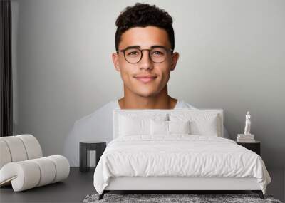 Attractive young Mexican man wearing a white t-shirt and glasses. Isolated on white background. Wall mural