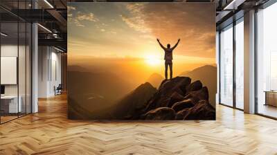 Happy man raising his arms jumping to the top of the mountain, successful businessman celebrating success on the cliff, business success concept silhouette backlit. Wall mural