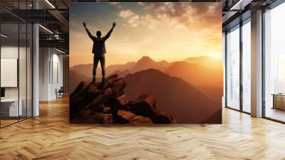 Happy man raising his arms jumping to the top of the mountain, successful businessman celebrating success on the cliff, business success concept silhouette backlit. Wall mural