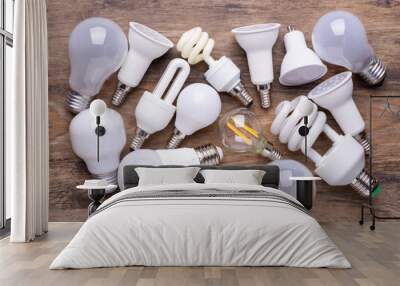 Different kinds of light bulbs on wooden background Wall mural