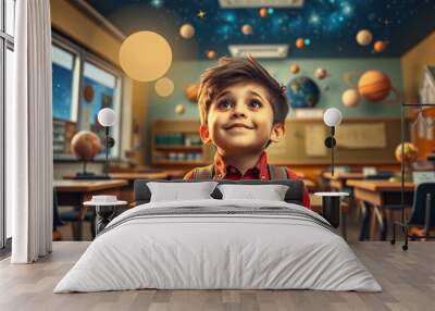 A cheerful schoolboy with a look of wonder on his face as he observes a starry night sky projected onto the classroom ceiling Wall mural