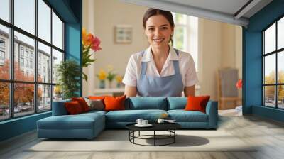 Joyful housekeeper wearing a crisp uniform and a bright smile  Wall mural