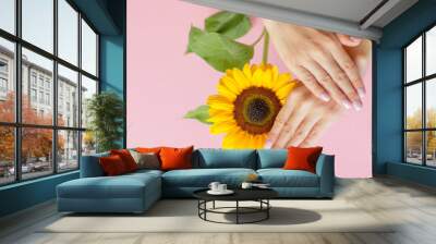 Stylish trendy female manicure. Beautiful young woman's hands on pink background with flower. Manicure concept. Wall mural