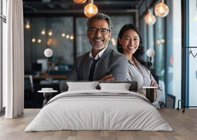 Happy smiling confident professional mature Latin business man and Asian business woman colleagues corporate managers standing in office, two diverse executives team laughing arms, Generative AI Wall mural