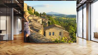 Montepulciano, Tuscany, Italy, Girl looks at the landscape of the city and countryside from the balcony Wall mural