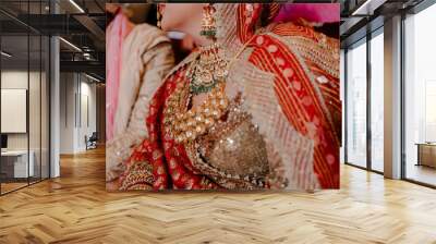 Portrait of an Indian bride wearing traditional red lehenga with gold jewellery and a heavy necklace
 Wall mural