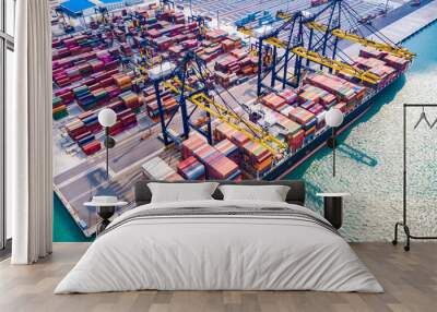 Cargo ship, loading and unloading goods at the deep sea port Wall mural