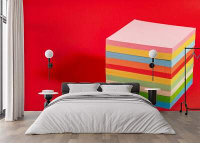 Stack of colorful sticky notes isolated on red background. Note block with memos Wall mural