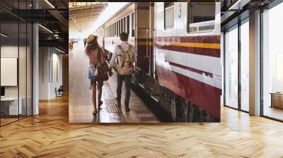 Two persone guy and girl travellers waiting for a train in asian train station Wall mural