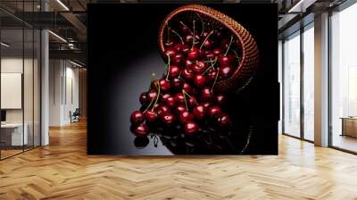 Fresh cherry in a wicker basket on a black background. Wall mural