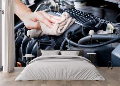 hand of a man holding a blue cloth caring, maintenance car and cleaning And engine car room	 Wall mural