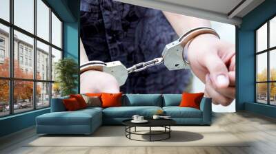 Men arrested and controlled by handcuffs on the wrist. The concept of offense and the law. Wall mural