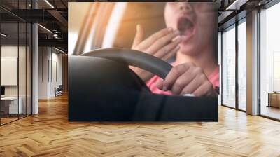 Sleepy woman While she was driving on the road. Concept of health and driving safety Wall mural