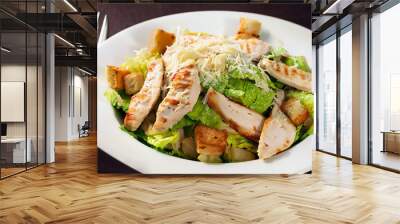 Caesar salad with chicken on a white plate, close-up. Generated AI Wall mural