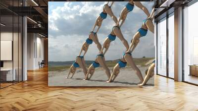 pyramid of people on the beach
 Wall mural