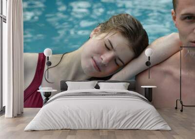 two teenagers relaxing in the swimming pool Wall mural