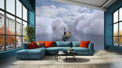 woman is sailing in a boat through the clouds Wall mural