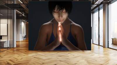 young woman praying in the dark Wall mural