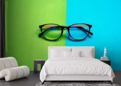 Glasses on two color pastel background Wall mural