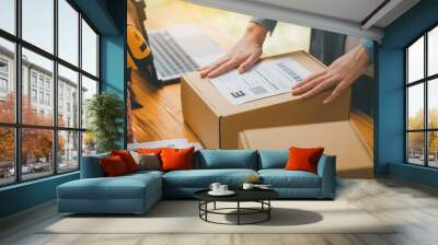 startup young female small business owners attaching shipping labels to cardboard boxes or parcels for delivery of customer orders-concept shopping online. Wall mural