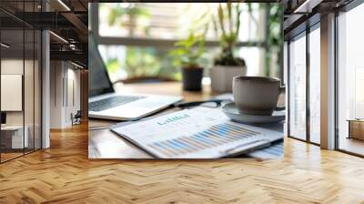 A modern office desk with a laptop financial reports and a cup of coffee Wall mural