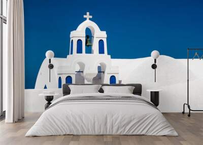 A white church with blue elements in Oia on Santorini island, Greece. Wall mural