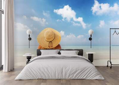 Beautiful young woman in sunhat lying relaxed on tropical beach in Maldives Wall mural