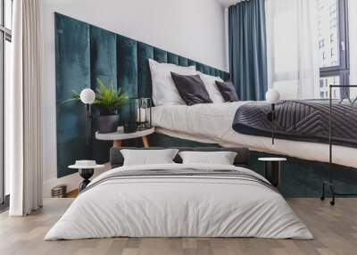 Cozy bedroom with comfortable bed in modern studio apartment. Wall mural