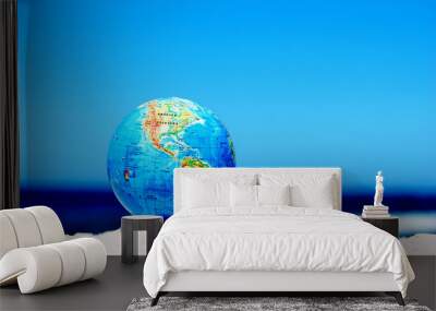 Earth globe on the beach. Ideal for Earth protection concepts Wall mural