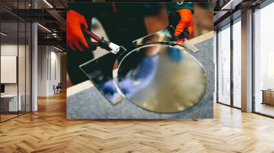 Glazier worker cutting glass with compass glass cutter in a workshop. Wall mural