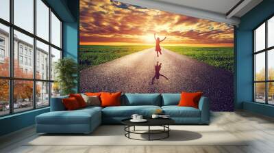 Happy woman jumping on long straight road, way towards sun Wall mural