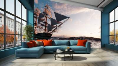 Pirate ship sailing on the ocean at sunset Wall mural