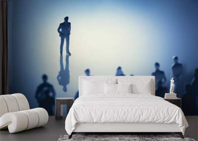 Single man standing in front of group of people. Wall mural