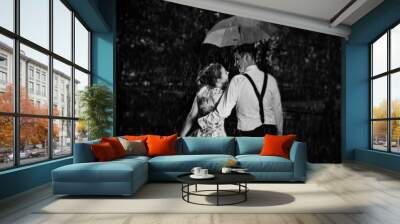 Young romantic couple in love flirting in rain. Black and white Wall mural