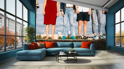 Leisure holidays travel trip. Group of diverse people standing on a rooftop. Teenage carefree lifestyle Wall mural