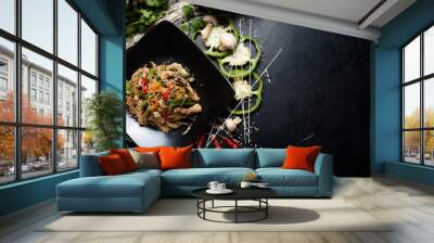 traditional oriental cuisine food preparing craft. rice noodle beef and vegetable on a plate. copyspace concept Wall mural