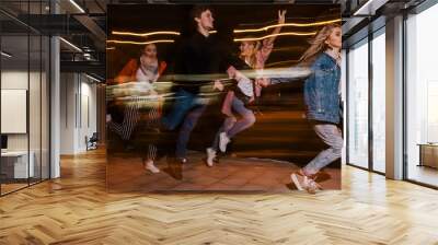 Youth movement in night city. Blurred background. Friends party, happy students outdoors, strong friendship Wall mural