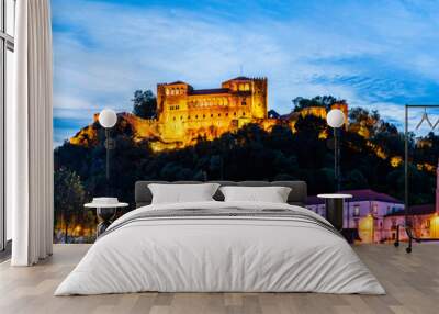 Skyline of the castle of Leiria on a hill top surrounded by trees and buildings in the old town of Leiria, Portugal Wall mural