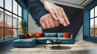 Wedding day. The groom places the ring on the bride's hand. Photo closeup Wall mural