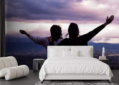 Christian worship and praise. Two young woman are praying and worshiping in the evening. Wall mural