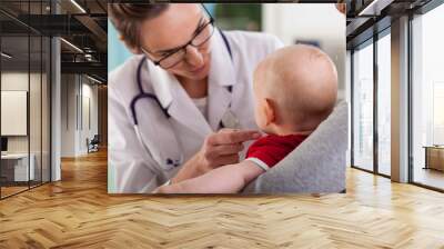 Baby boy with mother at doctor's office Wall mural