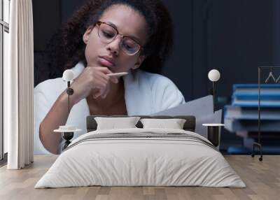 Black girl reading a document Wall mural