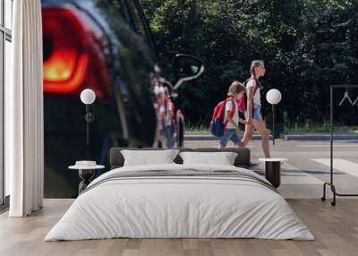 Children next to a car walking through pedestrian crossing to the school Wall mural