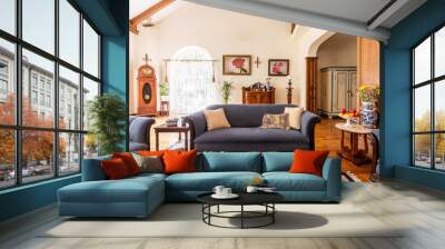 Cobalt blue sofa and other antique furniture on a wooden floor in a spacious living room interior of a classic mansion. Wall mural