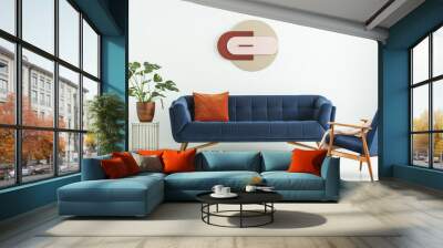 Creative geometric art on a white wall above an elegant blue sofa in a mid-century modern style living room interior. Real photo. Wall mural