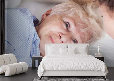 Elderly woman in bed Wall mural