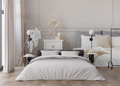 Flowers on nightstand table in delightful bedroom interior with grey and white design Wall mural